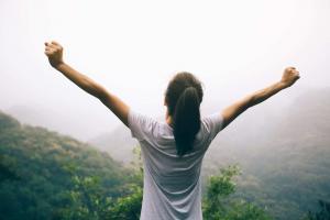 Happy teen with outstretched arms enjoying the view